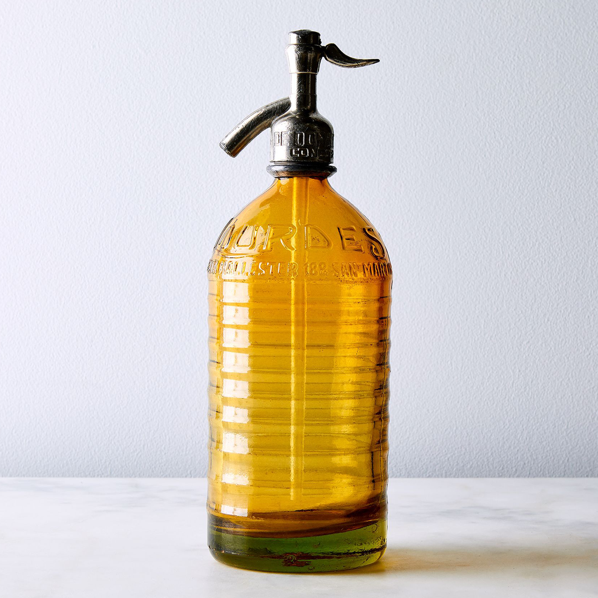 Amber hand-dipped Lourdes vintage Argentine seltzer bottle with wavy ridged profile