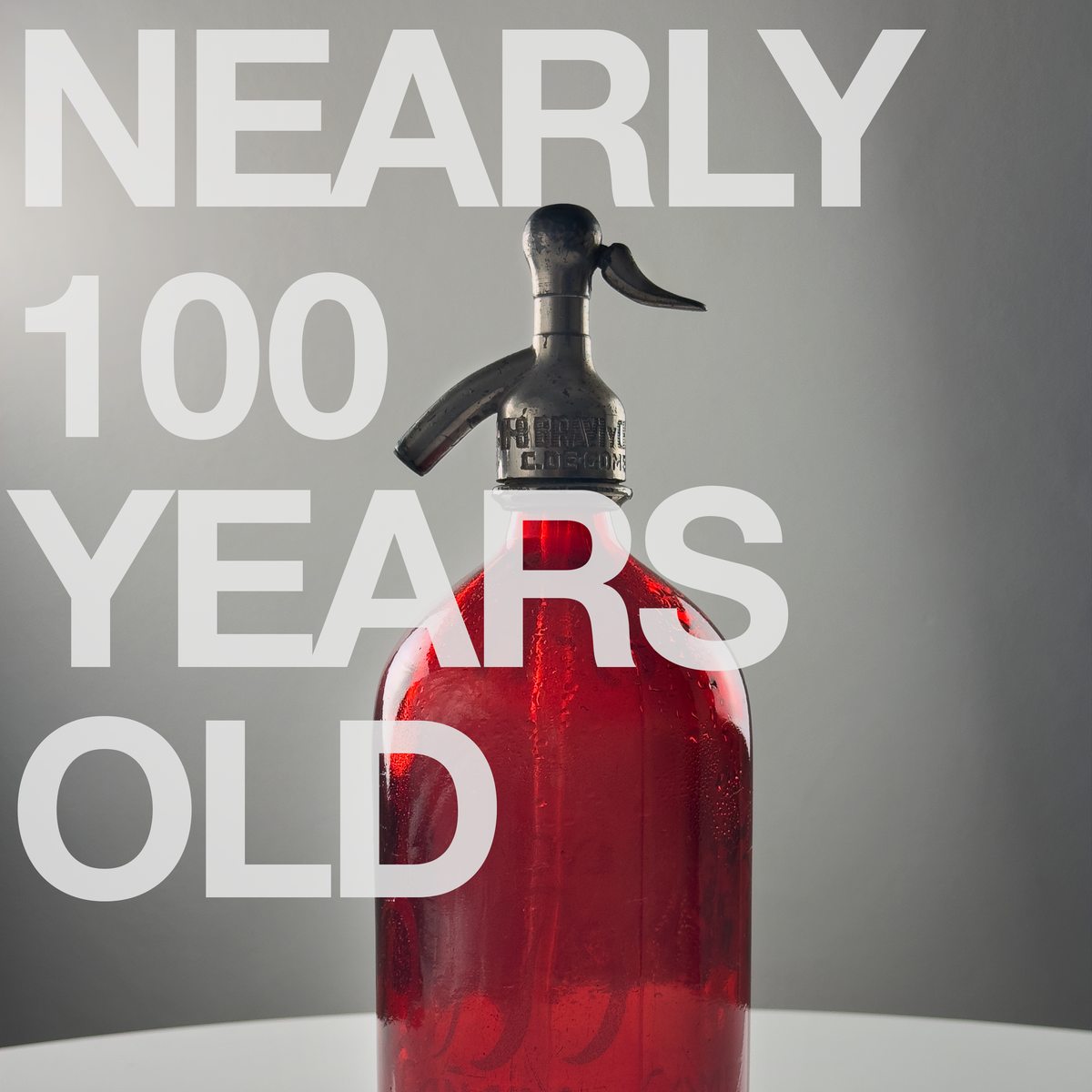 1 liter Red Lithographed Vintage Seltzer Bottle.